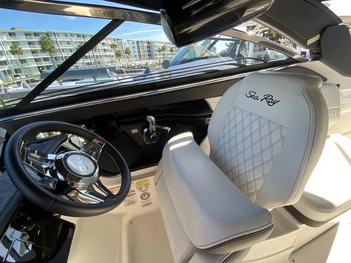 Double Trouble Yacht Photos Pics Interior of 2023 Sea Ray 260 SLX boat with luxurious seating and steering wheel.