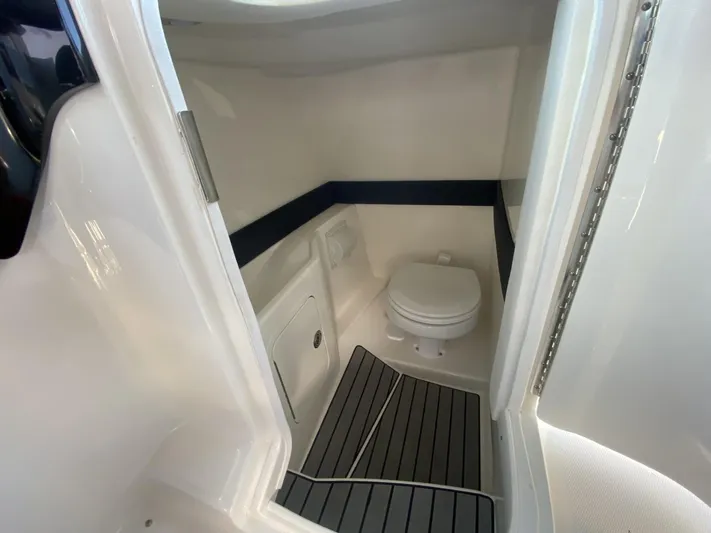 Double Trouble Yacht Photos Pics 2023 Sea Ray 260 SLX boat interior with compact marine toilet and sleek design.