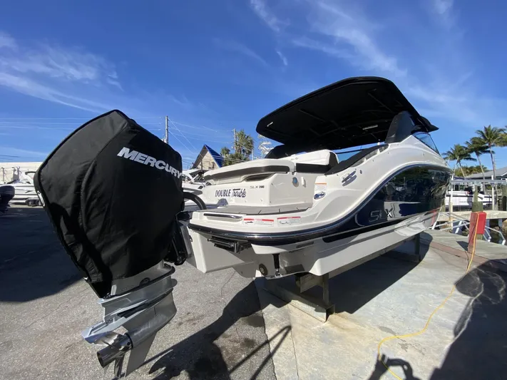 Double Trouble Yacht Photos Pics 2023 Sea Ray 260 SLX boat with Mercury engine, docked under clear blue sky.