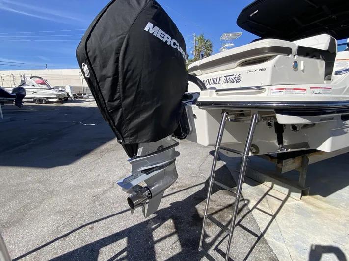 Double Trouble Yacht Photos Pics 2023 Sea Ray 260 SLX boat with Mercury engine and ladder in a marina setting.