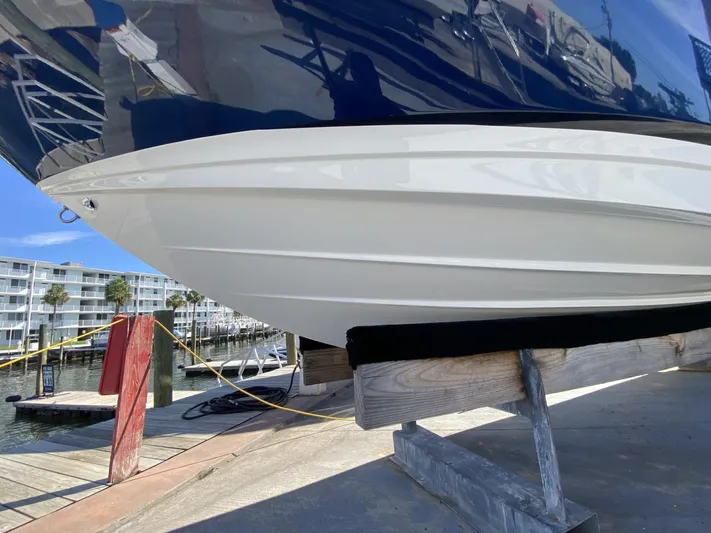 Double Trouble Yacht Photos Pics 2023 Sea Ray 260 SLX boat hull on dock, marina background.
