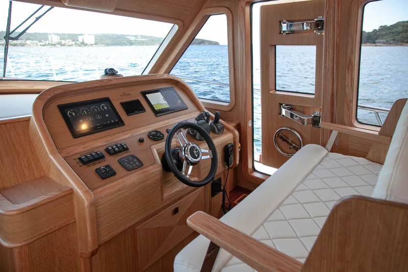 Mareluna Yacht Photos Pics Helm of 2023 Vicem 55 yacht with wooden dashboard and leather seating.