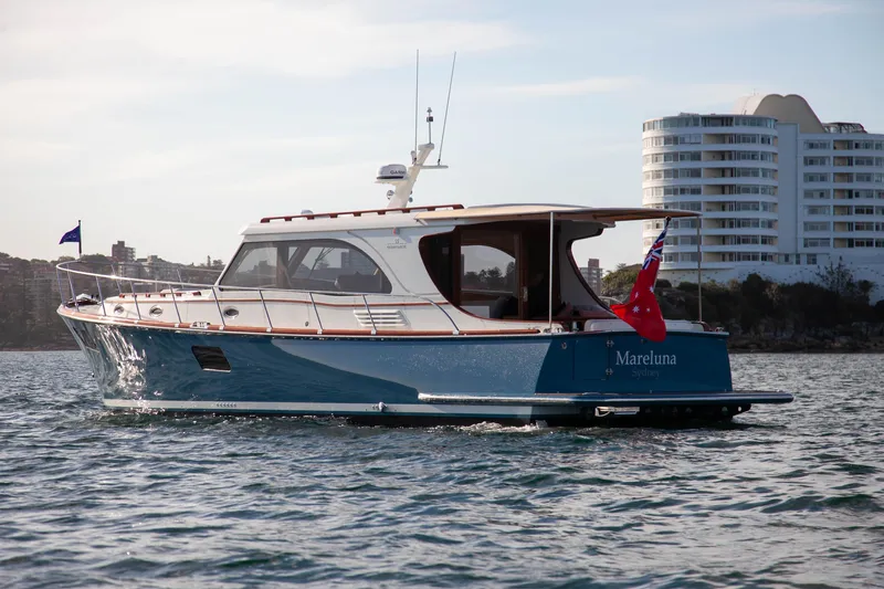 Mareluna Yacht Photos Pics 2023 Vicem 55 yacht cruising on water near modern buildings.