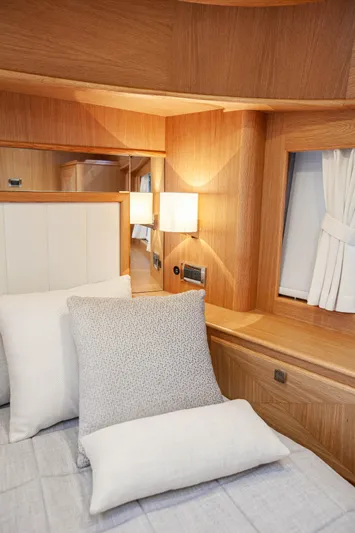 Mareluna Yacht Photos Pics Luxurious cabin interior of 2023 Vicem 55 yacht with elegant wood finish and cozy bedding.