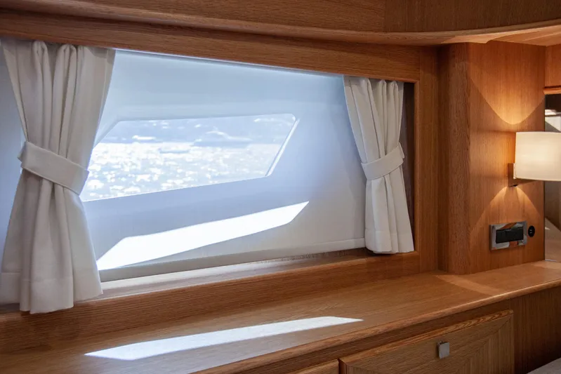 Mareluna Yacht Photos Pics Interior of 2023 Vicem 55 yacht with elegant wood finish and window curtains.