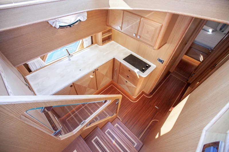 Mareluna Yacht Photos Pics Luxurious interior of 2023 Vicem 55 yacht featuring modern kitchen and wooden finishes.