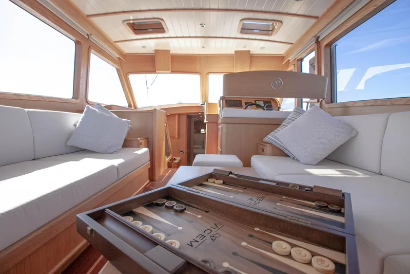 Mareluna Yacht Photos Pics Luxurious interior of 2023 Vicem 55 yacht with elegant seating and backgammon set.