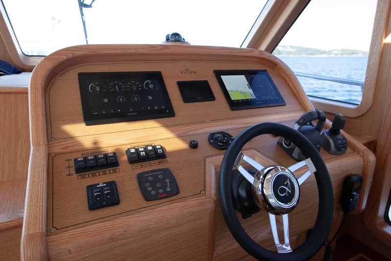 Mareluna Yacht Photos Pics 2023 Vicem 55 yacht helm with modern navigation controls and wooden finish.