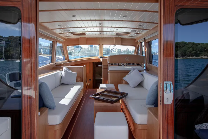 Mareluna Yacht Photos Pics Luxurious interior of 2023 Vicem 55 yacht with elegant wood finish and plush seating.