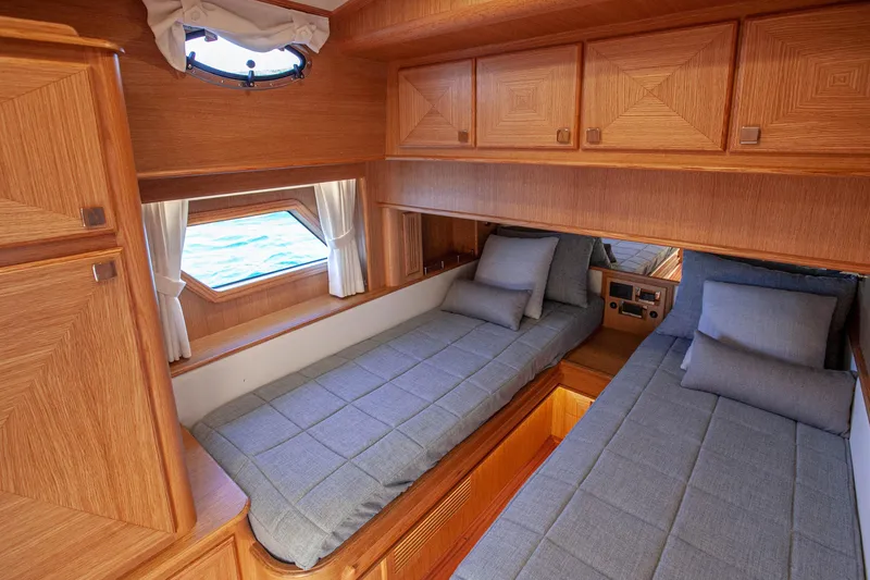Mareluna Yacht Photos Pics Luxurious 2023 Vicem 55 yacht cabin with twin beds and wooden interior.