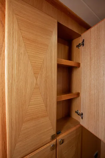 Mareluna Yacht Photos Pics 2023 Vicem 55 yacht interior with open wooden cabinet and shelves.
