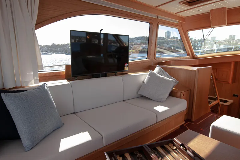 Mareluna Yacht Photos Pics Luxurious interior of 2023 Vicem 55 yacht with sofa, TV, and scenic windows.