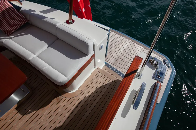Mareluna Yacht Photos Pics Luxurious 2023 Vicem 55 yacht deck with white seating and teak flooring.