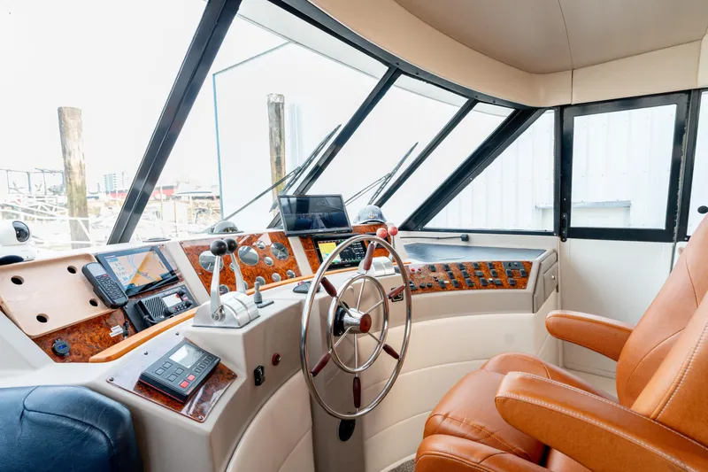 Seaclusion Yacht Photos Pics Interior of 1998 Bayliner 4788 Pilot House Motoryacht cockpit with navigation equipment.