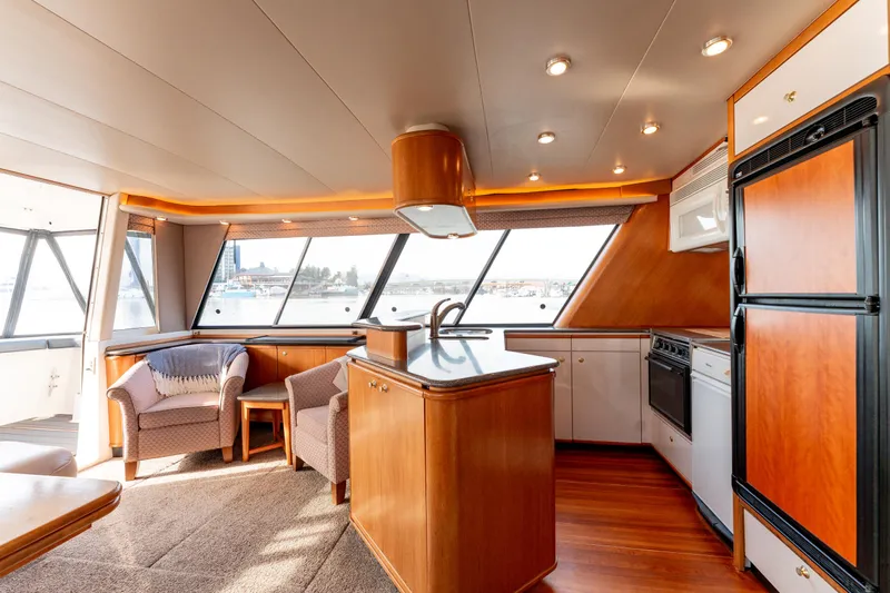 Seaclusion Yacht Photos Pics Luxurious interior of 1998 Bayliner 4788 Pilot House Motoryacht with modern kitchen and seating area.