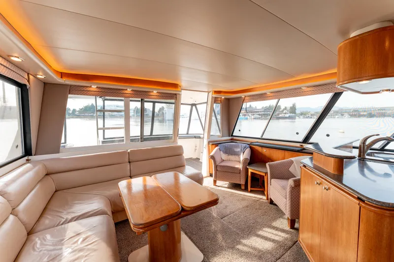 Seaclusion Yacht Photos Pics Luxurious interior of 1998 Bayliner 4788 Pilot House Motoryacht with panoramic windows and elegant seating.