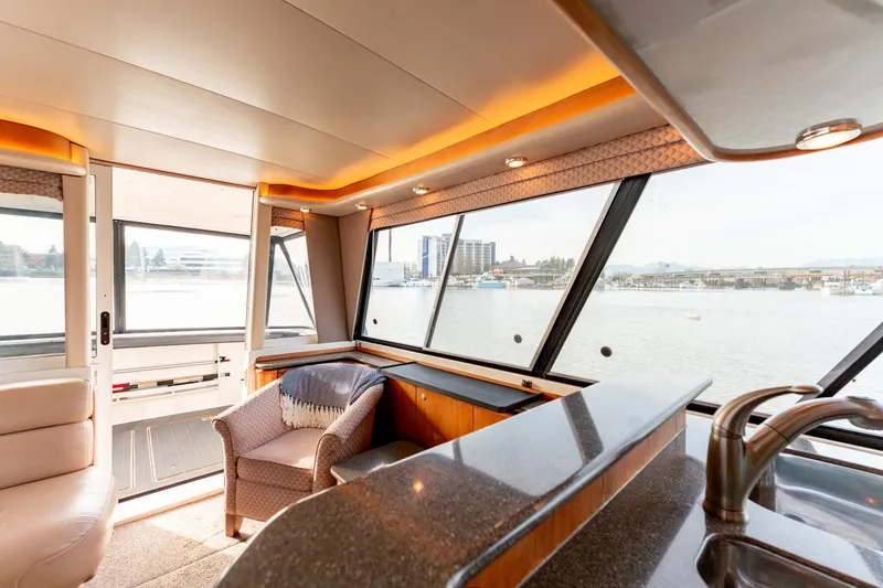 Seaclusion Yacht Photos Pics Luxurious interior of 1998 Bayliner 4788 Pilot House Motoryacht with waterfront view.