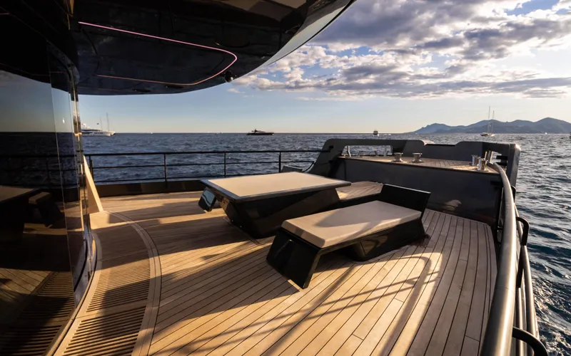 K+ Yacht Photos Pics Luxurious deck of 2023 Maori M 125 yacht with sun loungers and ocean view.