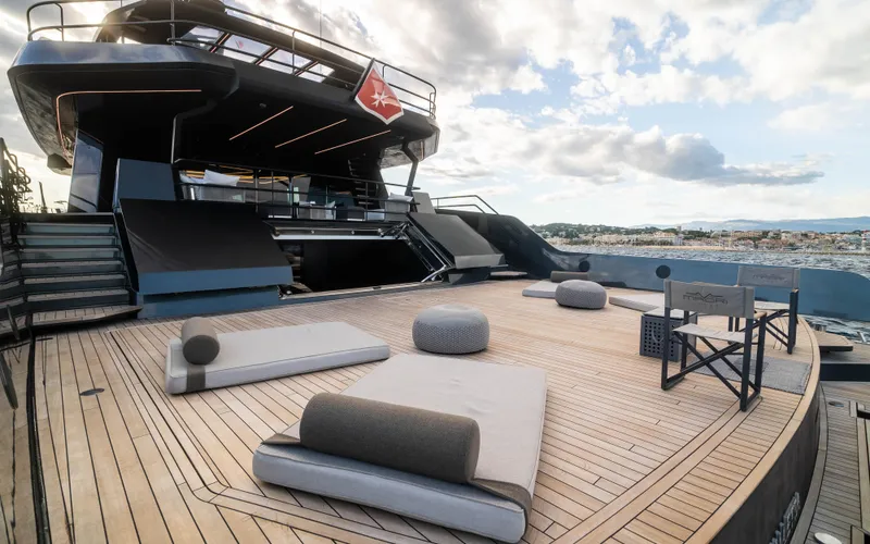 K+ Yacht Photos Pics Luxurious Maori M 125 yacht deck with modern seating, 2023 model, under a partly cloudy sky.