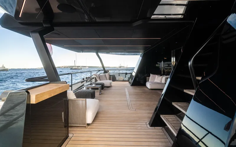 K+ Yacht Photos Pics Luxurious deck of 2023 Maori M 125 yacht with modern seating and ocean view.