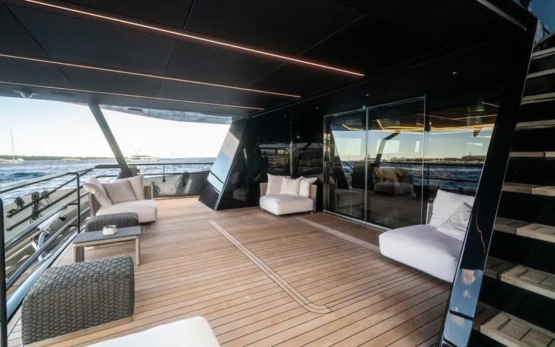 K+ Yacht Photos Pics Luxurious deck of 2023 Maori M 125 yacht with modern seating and ocean view.