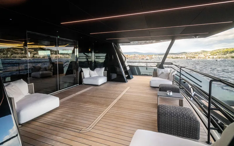 K+ Yacht Photos Pics Luxurious deck of 2023 Maori M 125 yacht with modern seating and scenic ocean view.