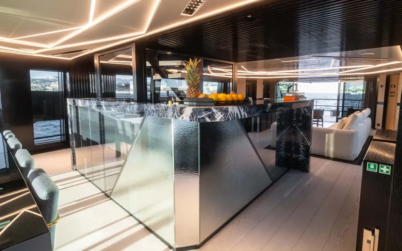 K+ Yacht Photos Pics Luxurious interior of 2023 Maori M 125 yacht with modern design and elegant bar area.