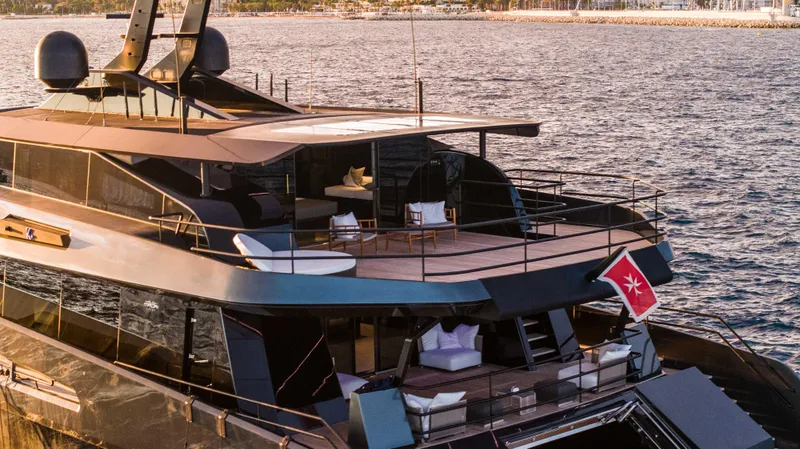 K+ Yacht Photos Pics Luxurious 2023 Maori M 125 yacht on serene waters, featuring elegant outdoor seating and sleek design.
