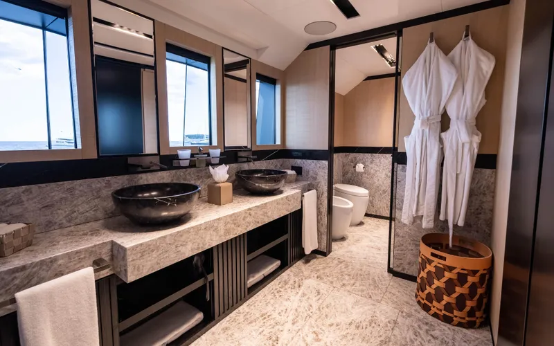 K+ Yacht Photos Pics Luxurious yacht bathroom with dual sinks, robes, and modern design, Maori M 125, 2023 model.