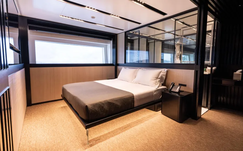 K+ Yacht Photos Pics Luxurious bedroom interior on Maori M 125 yacht, 2023 model, featuring modern design and large window.