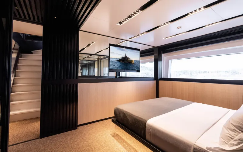 K+ Yacht Photos Pics Luxurious bedroom interior of 2023 Maori M 125 yacht with modern design and large window.