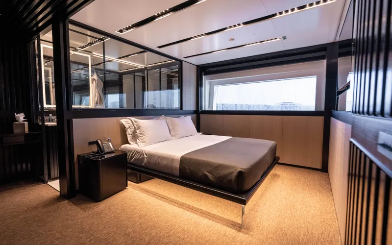 K+ Yacht Photos Pics Luxurious bedroom interior on Maori M 125 yacht, 2023 model, featuring modern design and large window.