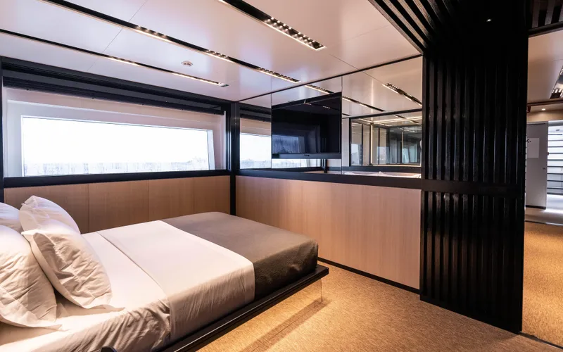 K+ Yacht Photos Pics Luxurious bedroom interior on 2023 Maori M 125 yacht, featuring modern design and large window.