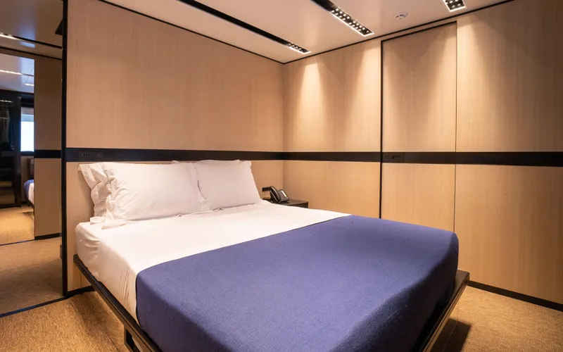 K+ Yacht Photos Pics Luxurious bedroom interior in 2023 Maori M 125 yacht, featuring modern design and cozy ambiance.