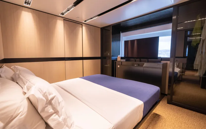K+ Yacht Photos Pics Luxurious bedroom interior in 2023 Maori M 125 yacht, featuring modern design and elegant furnishings.
