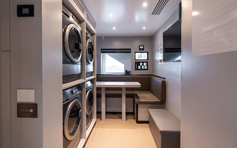 K+ Yacht Photos Pics Modern laundry room with stacked machines and seating, Maori M 125, 2023 model.