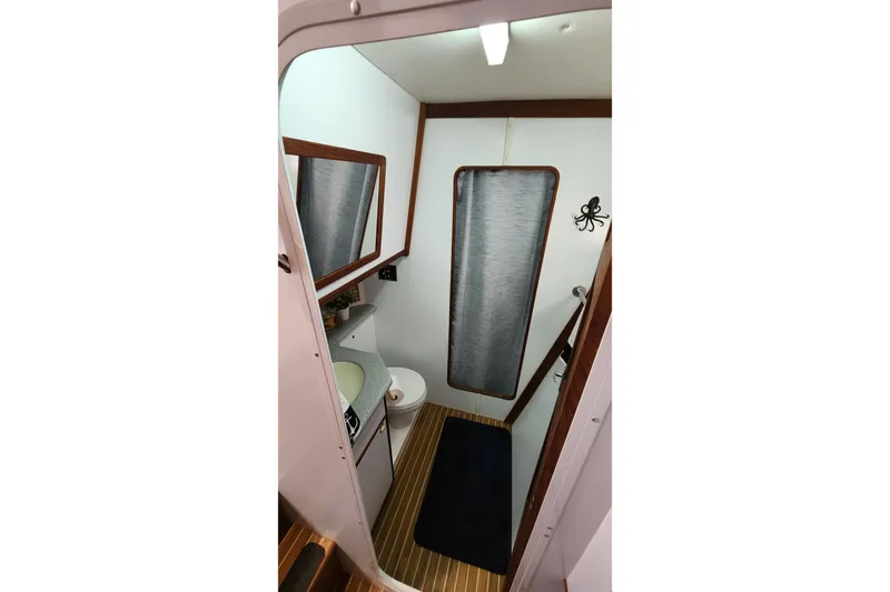Tahawus Yacht Photos Pics Bathroom interior of 2005 Endeavour 44 TrawlerCat with wood accents and nautical decor.