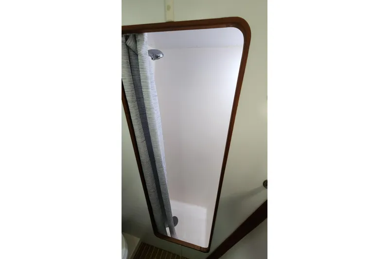 Tahawus Yacht Photos Pics Interior view of 2005 Endeavour 44 TrawlerCat shower area with curtain and wooden trim.