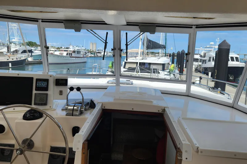 Tahawus Yacht Photos Pics 2005 Endeavour 44 TrawlerCat helm view with marina background, showcasing navigation instruments.