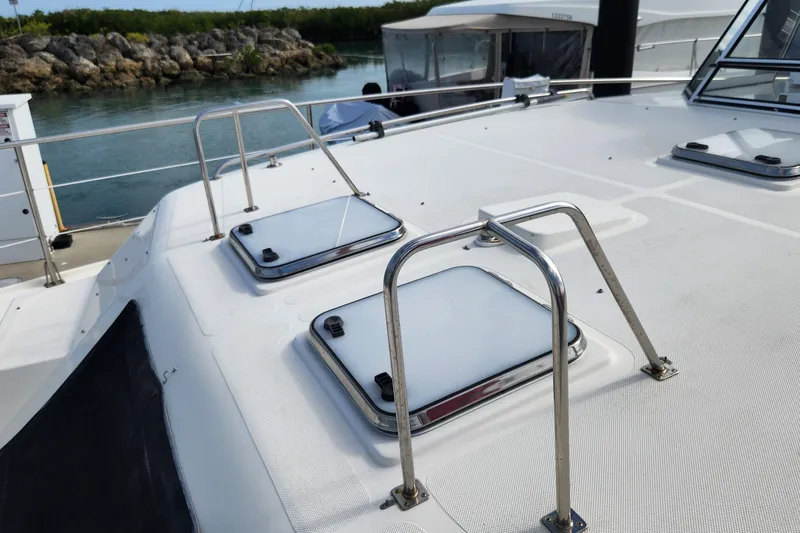 Tahawus Yacht Photos Pics 2005 Endeavour 44 TrawlerCat deck with hatches and railing, docked by water.