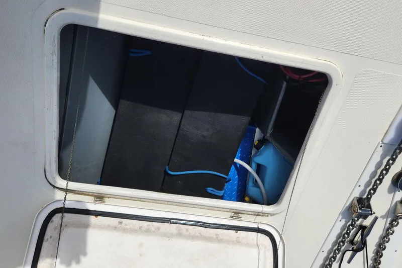 Tahawus Yacht Photos Pics Open hatch on 2005 Endeavour 44 TrawlerCat, revealing storage compartment with equipment.