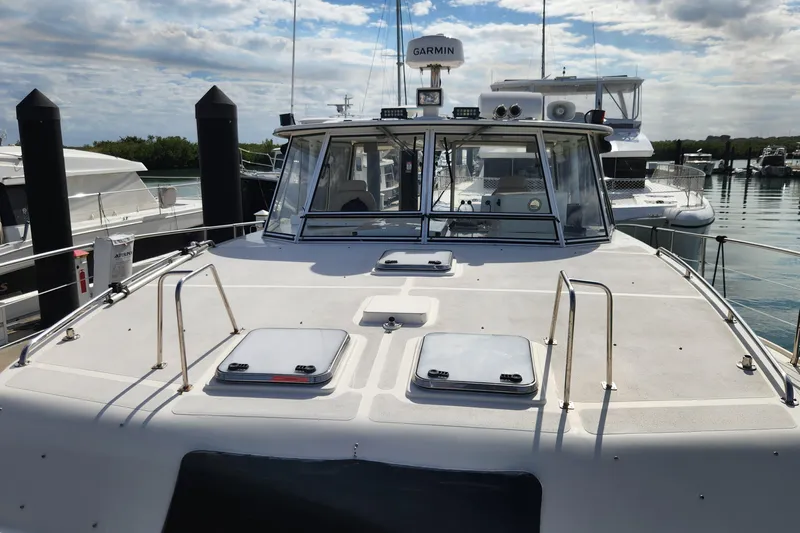 Tahawus Yacht Photos Pics 2005 Endeavour 44 TrawlerCat docked at marina under cloudy sky.