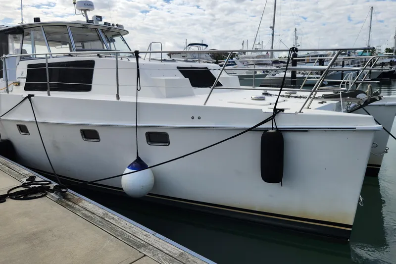 Tahawus Yacht Photos Pics 2005 Endeavour 44 TrawlerCat docked at marina under cloudy sky.