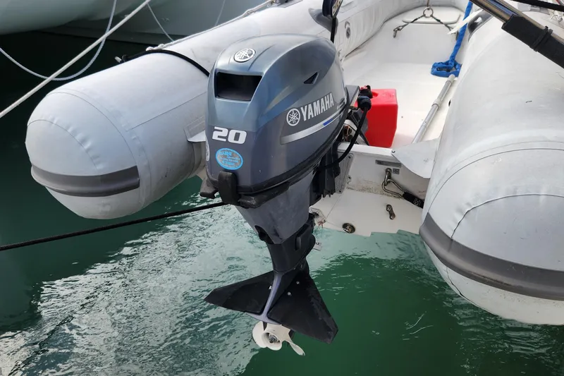 Tahawus Yacht Photos Pics Inflatable boat with Yamaha 20 outboard motor, docked on water.