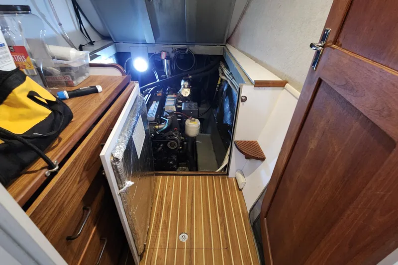 Tahawus Yacht Photos Pics Engine room of 2005 Endeavour 44 TrawlerCat with wooden flooring and open access panel.