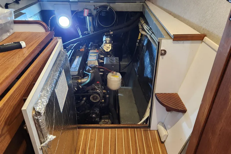 Tahawus Yacht Photos Pics Engine room of 2005 Endeavour 44 TrawlerCat with visible machinery and wooden flooring.