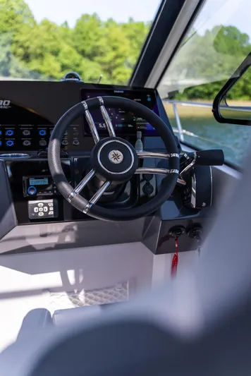  Yacht Photos Pics 2025 Nautic 880 boat steering wheel and dashboard, featuring modern controls and sleek design.