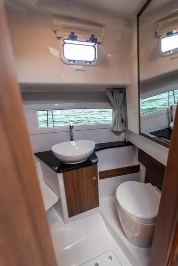  Yacht Photos Pics Modern bathroom interior on Nautic 880 boat, 2025 model, featuring sleek design and compact amenities.