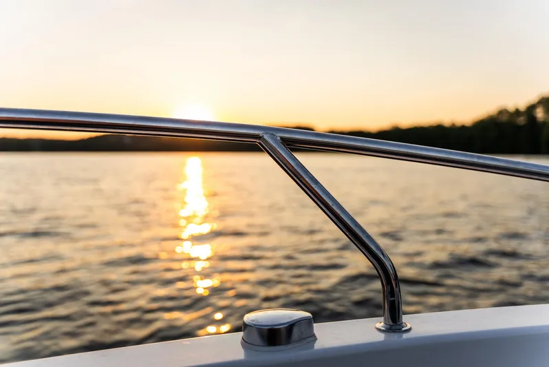  Yacht Photos Pics Sunset view from Nautic 880 boat, 2025 model, with serene water reflections.