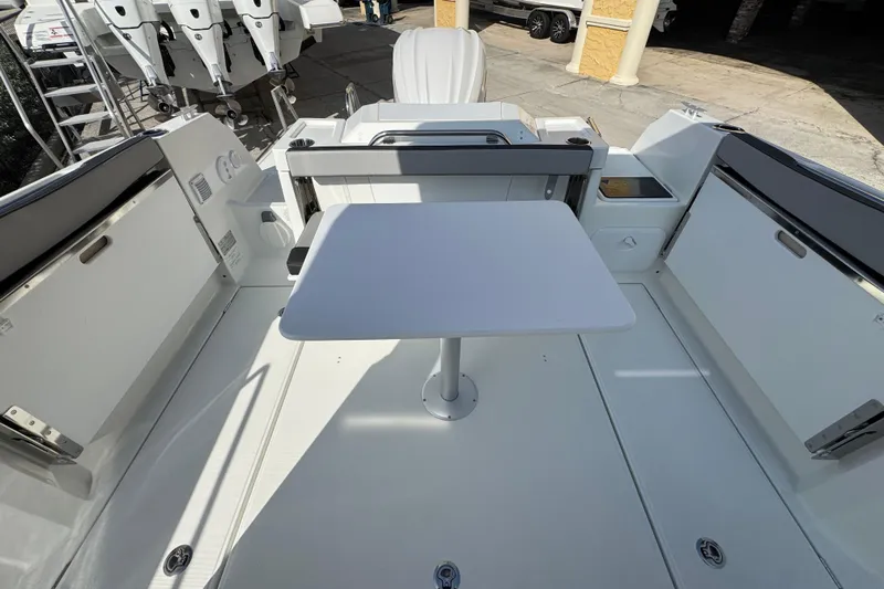  Yacht Photos Pics 2026 Jeanneau NC Sport 795 Series 2 boat deck with table and seating area.